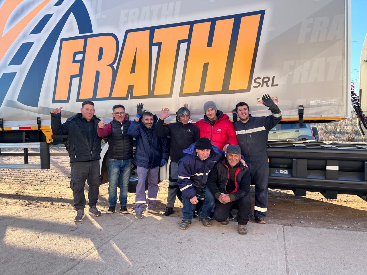 Equipo de choferes y taller de Frathi frente a una unidad